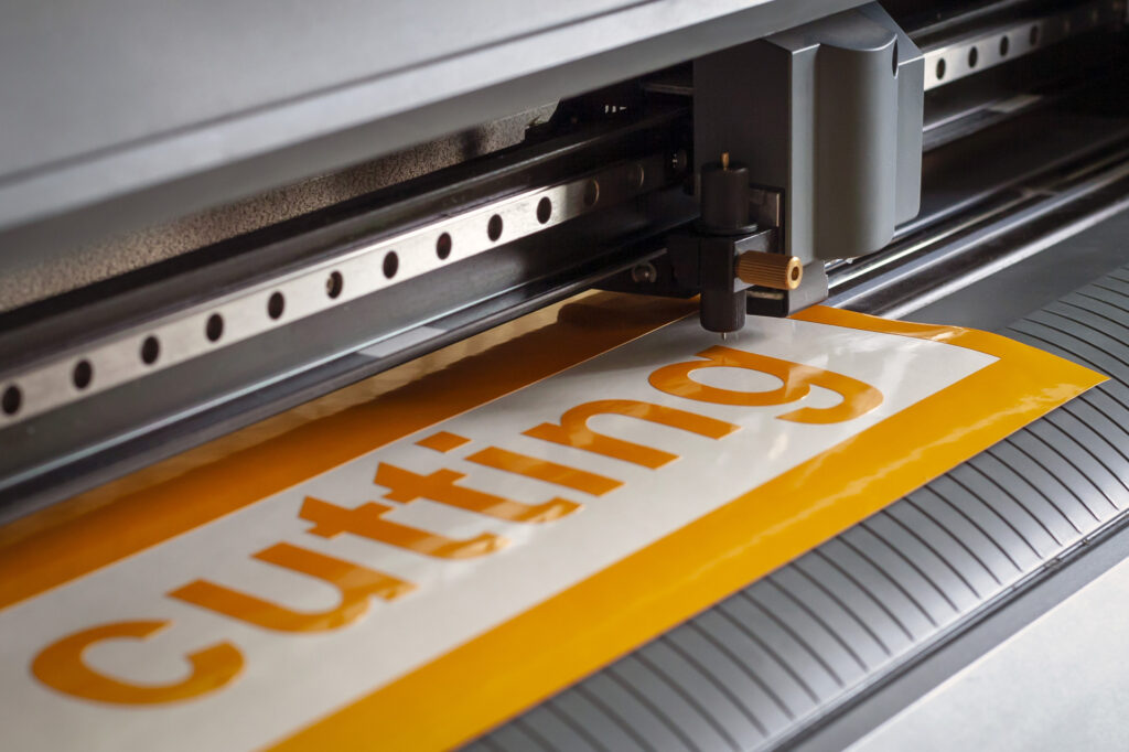 Cutting plotter close-up. The process of cutting a vinyl film.