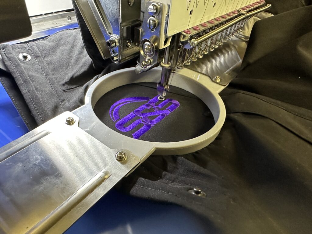 How much does embroidery cost in Nampa? It all depends on the design. Here, a single color logo embroidered onto a denim coat