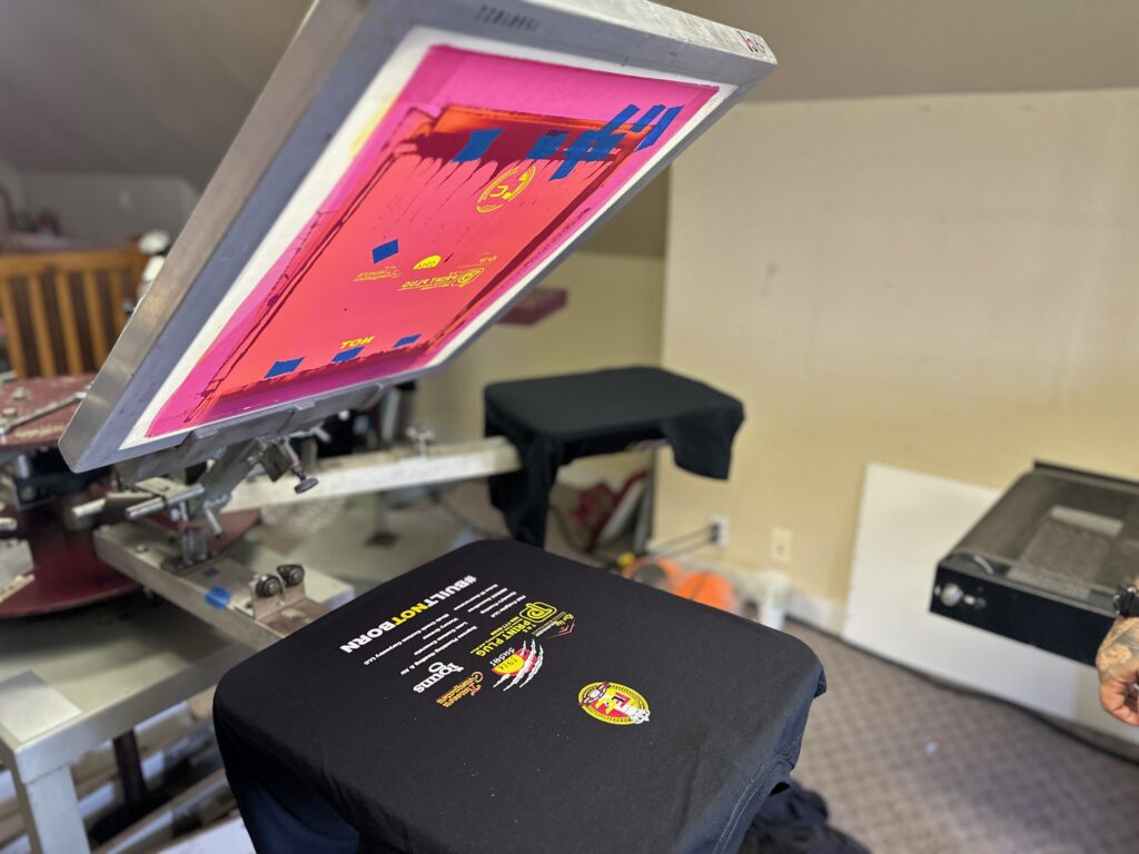 Multi-color custom team t-shirts on the screen press