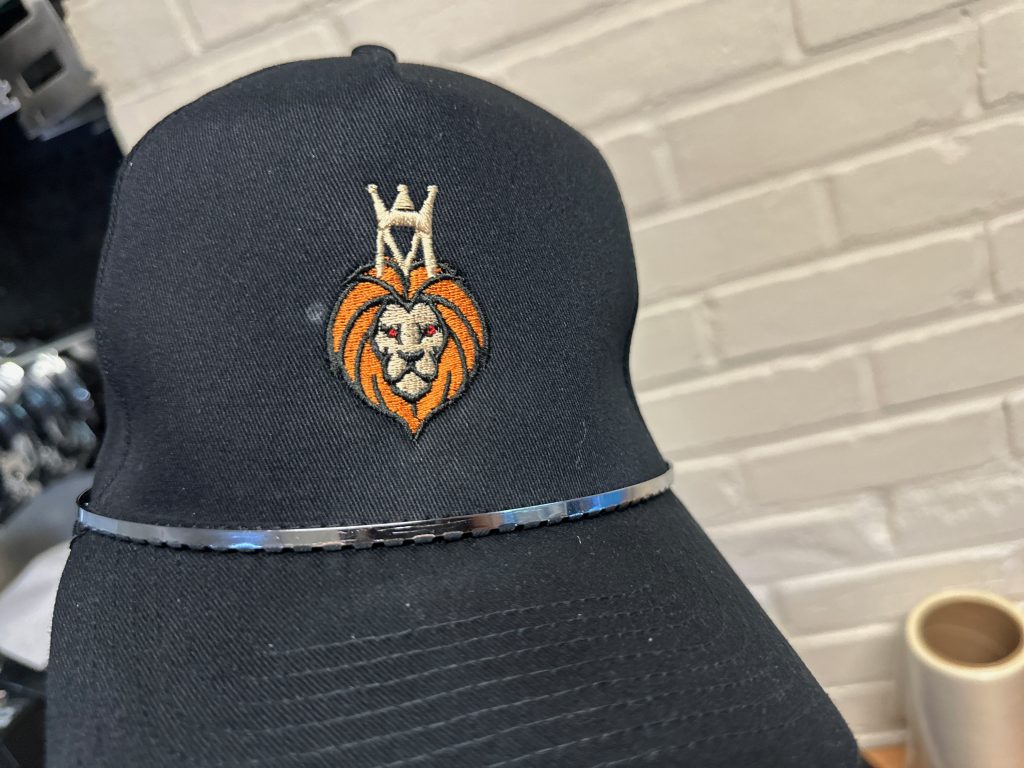 Logo design and embroidery on a black baseball cap
