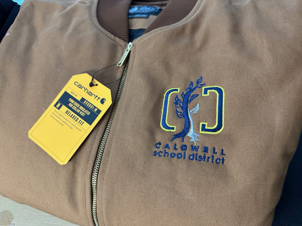 Custom embroidered logo on left chest of jackets for a local school